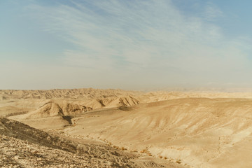 Fototapeta na wymiar Landscape of mountain hill dry desert in Israel. Valley of sand, rocks and stones in hot middle east tourism place.