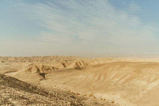 Landscape of mountain hill dry desert in Israel. Valley of sand, rocks and stones in hot middle east tourism place.