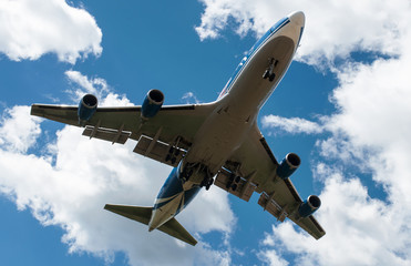 The plane on a background of blue sky and white clouds.