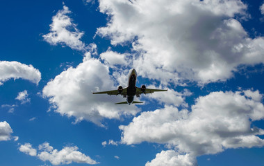 The plane on a background of blue sky and white clouds.