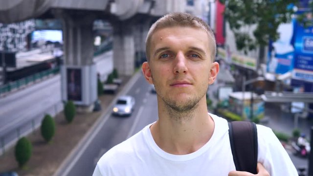 Young Man Portrait Looking In Camera In The City. 4K. 