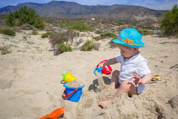 Little boy playing in the sand on holidays in Greece