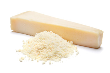 a piece of Parmesan and grated cheese on white background