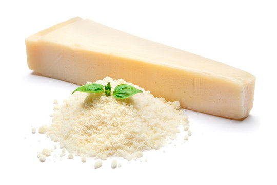 a piece of Parmesan and grated cheese on white background