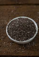 Chia seeds on dark wooden surface
