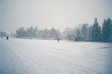 Winter day in a snowfall in the town.