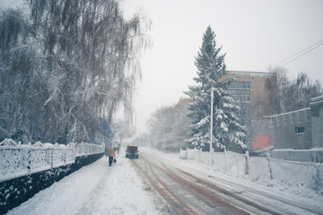 Winter day in a snowfall in the town.