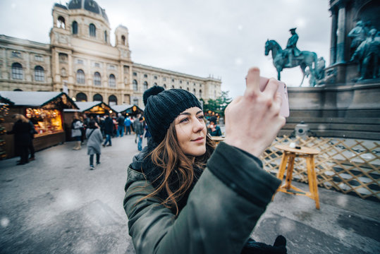 Young woman taking photo on smartphone
