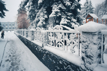 Winter day in a snowfall in the town.