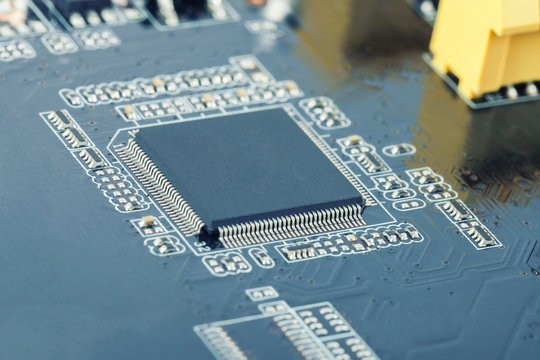 Electronic manufacturing and repair concept - close up studio shot of microcircuit