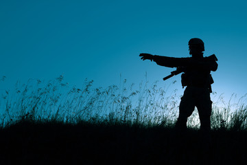 military soldier with weapons at sunset. shot, holding gun, colorful sky. military concept.
