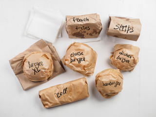 Burgers roll french fries strips on paper package