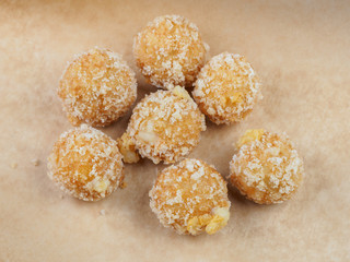 Tasty cheese balls on paper for baking