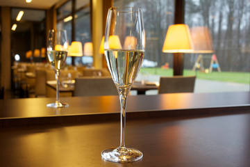 Glass of champagne on the table in the restaurant.