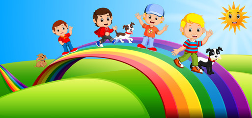 Obraz na płótnie Canvas Happy kids and dogs standing over the rainbow