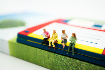 Miniature people, woman chill out on disk drive using as business and education and social concept background