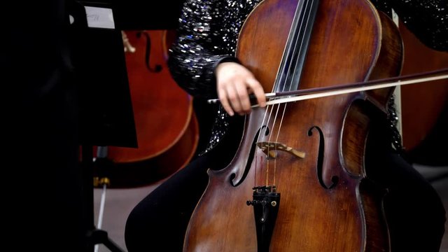 A close up footage of a female person playing on a double bass...