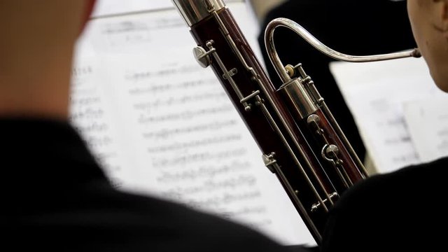 Close up footage of a musician playing on his bassoon...