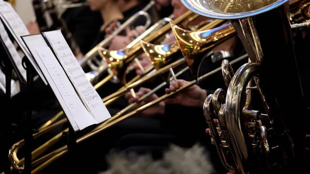 Close up shot of a baritone horn and several trumpets and trombone in the back