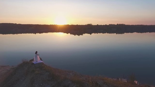 Girl lets a bird on lake