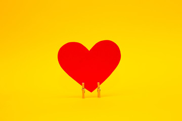 Fototapeta na wymiar Red paper heart on yellow background. Happy Valentines Day background. Love concept