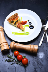 Slice of vegetarian pizza with tomatoes, broccoli and cheese