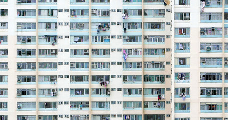 Fototapeta na wymiar Vertical exterior apartment residential building in Hong Kong city