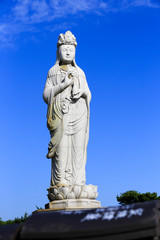 Fototapeta na wymiar The largest stone statue of Guan yin at the top of the hill of Naksan temple, It is the oldest Buddhist temple in the north of Naksan Beach, South Korea.Oct 5, 2017