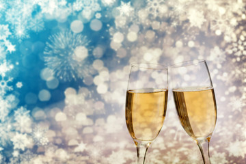 Champagne glasses on sparkling background