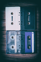 Old cassette tapes with a wooden background
