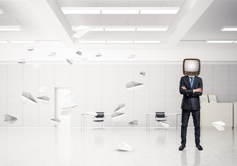 Businessman with an old TV instead of head.