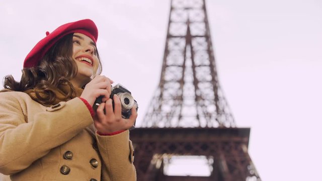 Creative girl catching on camera positive moments in Paris, enjoying hobby