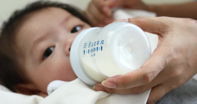 baby sucking milk from bottle