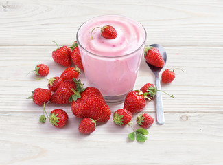 Yogurt with strawberry on white wooden table. Fresh yogurt. Healthy food concept. High resolution product.