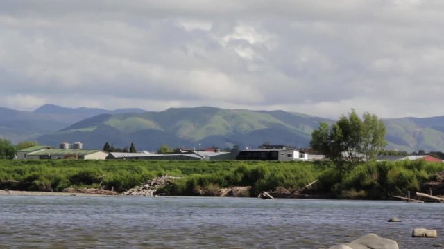 River flowing and green mountains in the background landscape