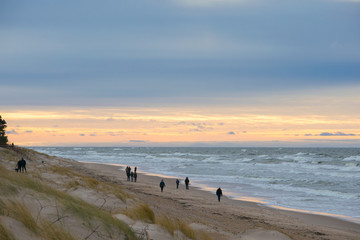 People walking on beach in winter evening in Palanga 