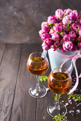 Buds of red roses and glases of wine