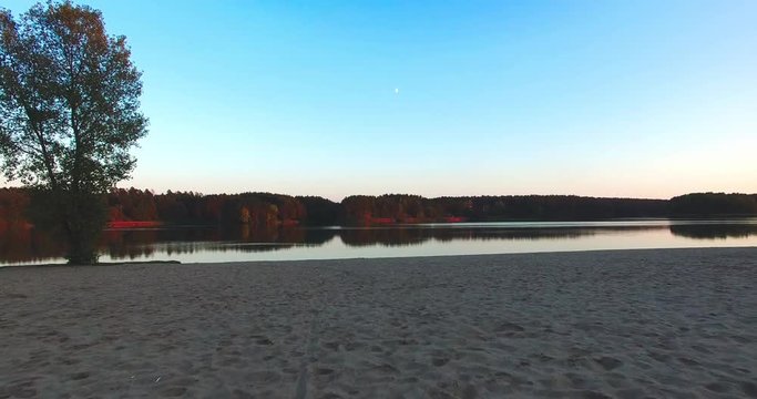 Nature landscape sandy beach at sunset river and sky calm windless weather