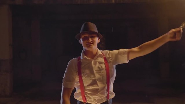 Male artist performing fire show at dark in slow motion.