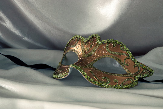 Image of elegant venetian mask over silk background.