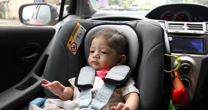 baby boy sitting in car seat of safety driving road trips