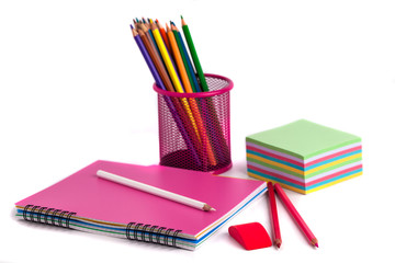 Fototapeta premium colored pencils in the basket, Eraser and notebook on white background