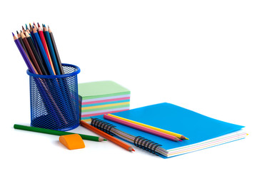 Fototapeta premium colored pencils in the basket, Eraser and notebook on white background