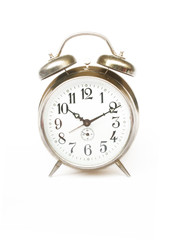 Rustic vintage desk alarm clock at the white background  