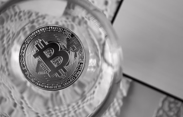 coins bitcoins in a wine glass,close-up