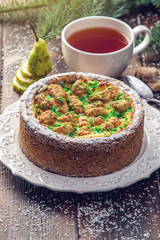 Homemade Christmas or New Year holiday pear pie decorated in a rustic style. Concept of festive desserts