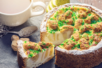 Homemade Christmas or New Year holiday pear pie decorated in a rustic style. Concept of festive desserts