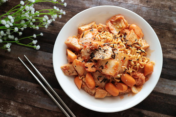 korean spicy instant noodles with kimchi and chicken breast on the wood