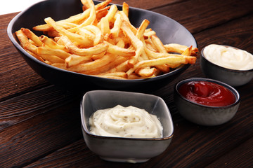 Red and white french fries chips with ketchup and mayonnaise