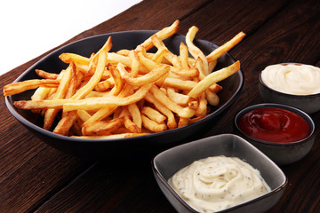 Red and white french fries chips with ketchup and mayonnaise